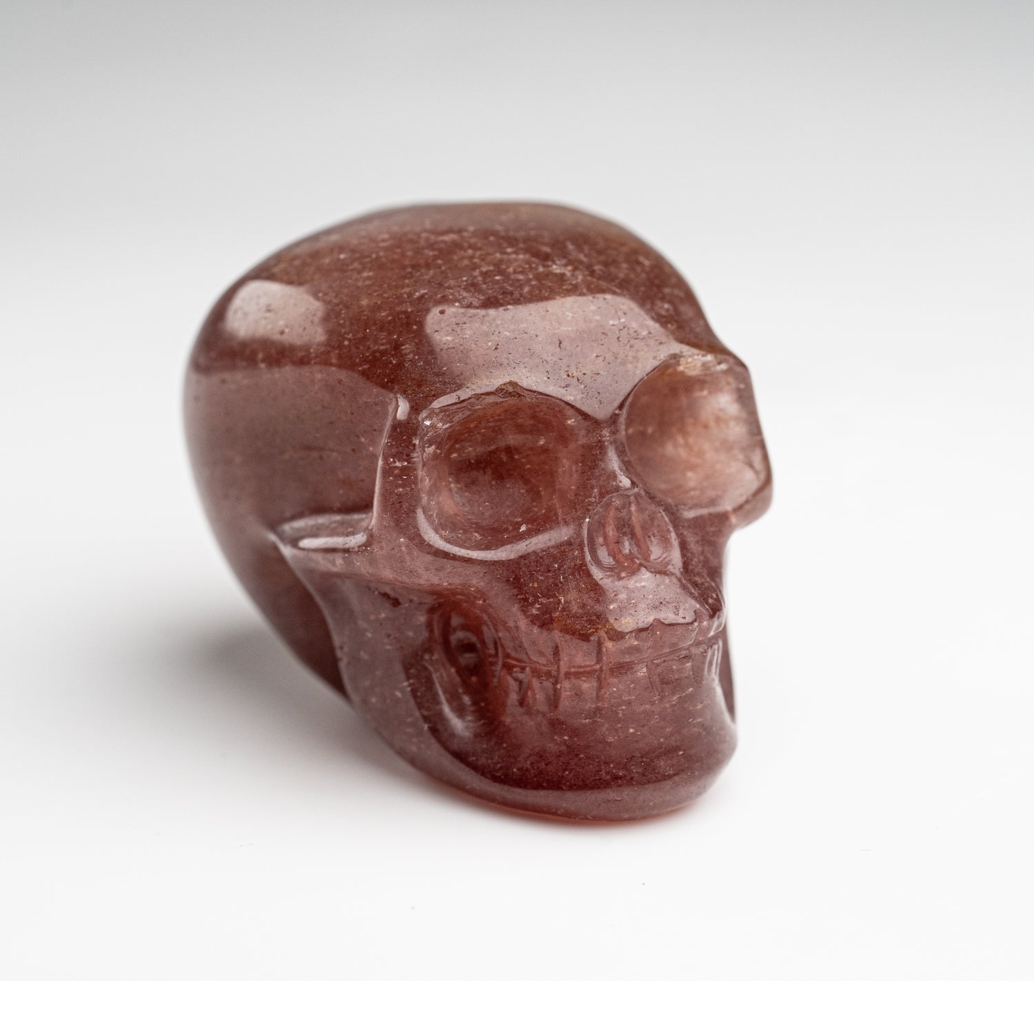 Polished Strawberry Quartz Skull Carving (125.4 grams)