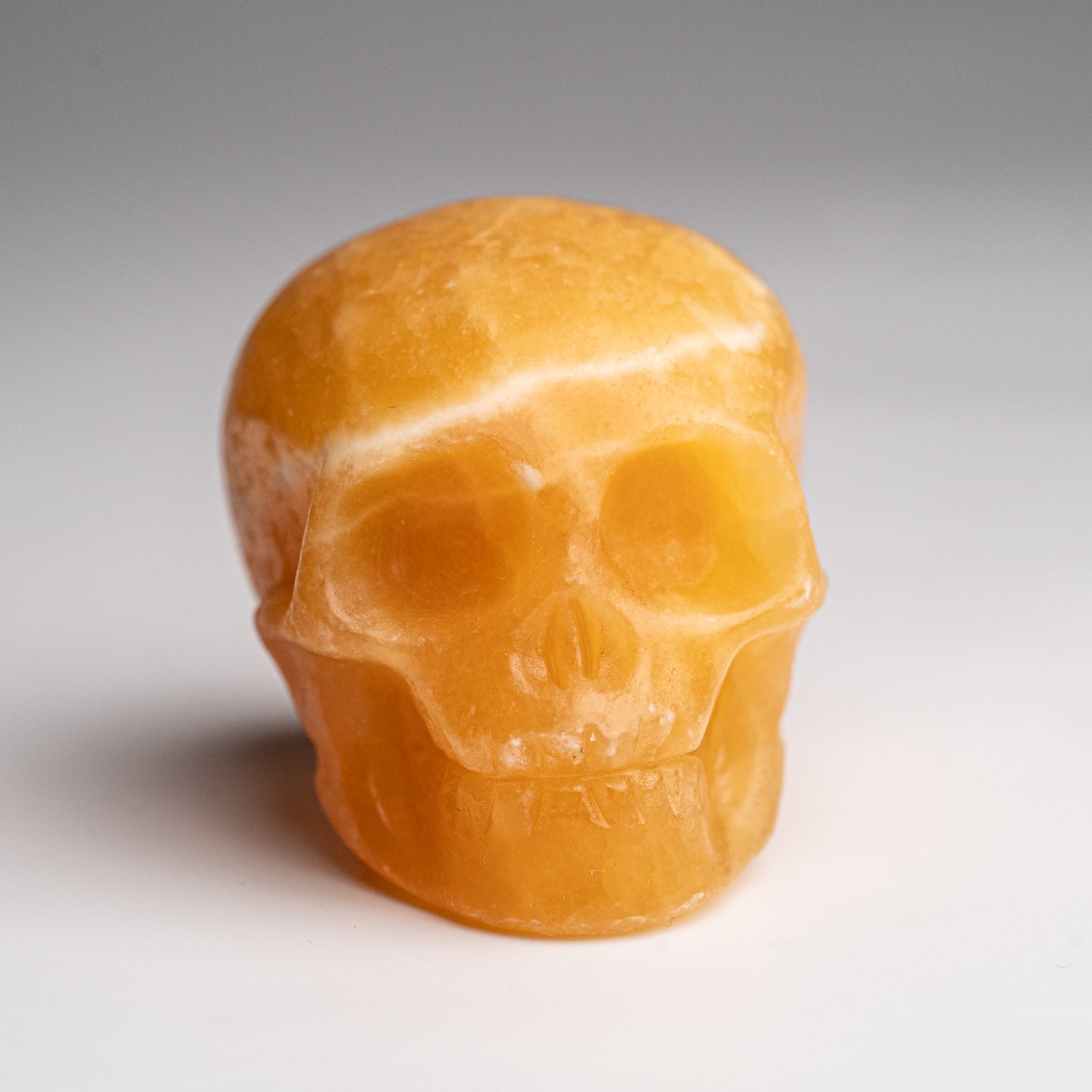 Polished Orange Calcite Skull Carving (127.4 grams)