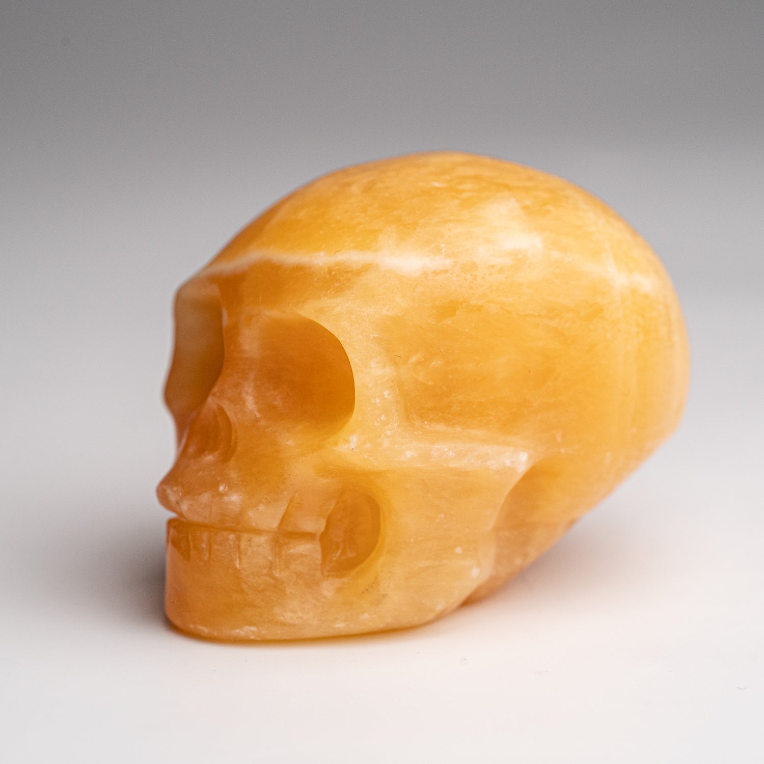 Polished Orange Calcite Skull Carving (127.4 grams)