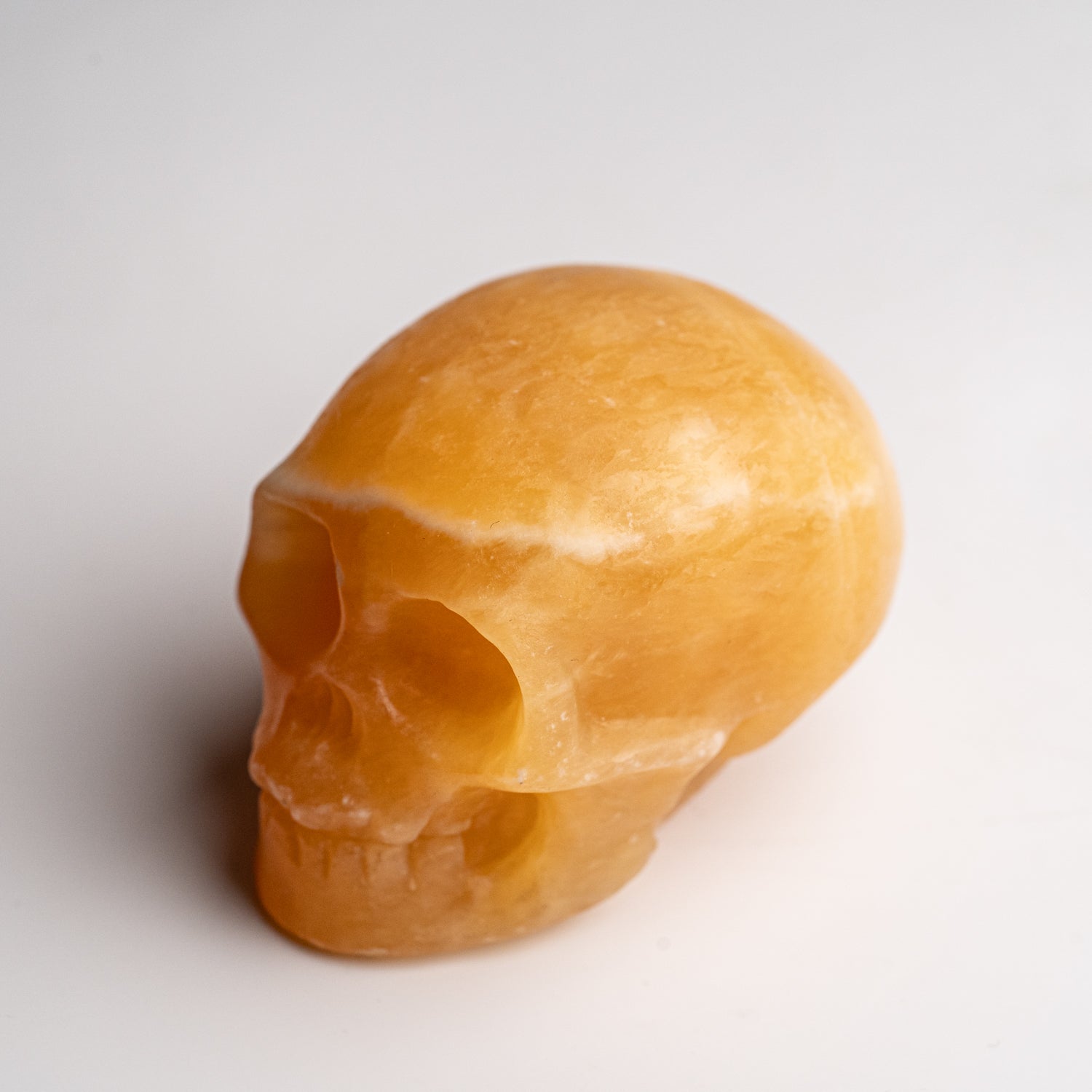 Polished Orange Calcite Skull Carving (127.4 grams)