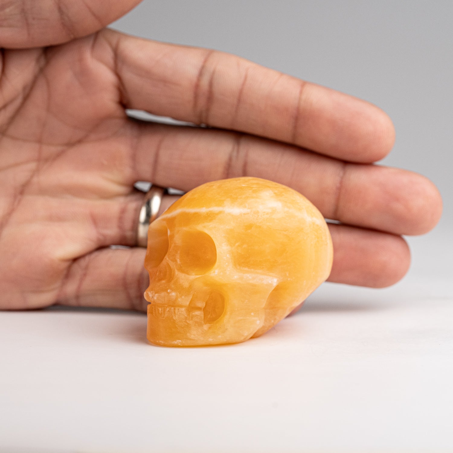 Polished Orange Calcite Skull Carving (127.4 grams)